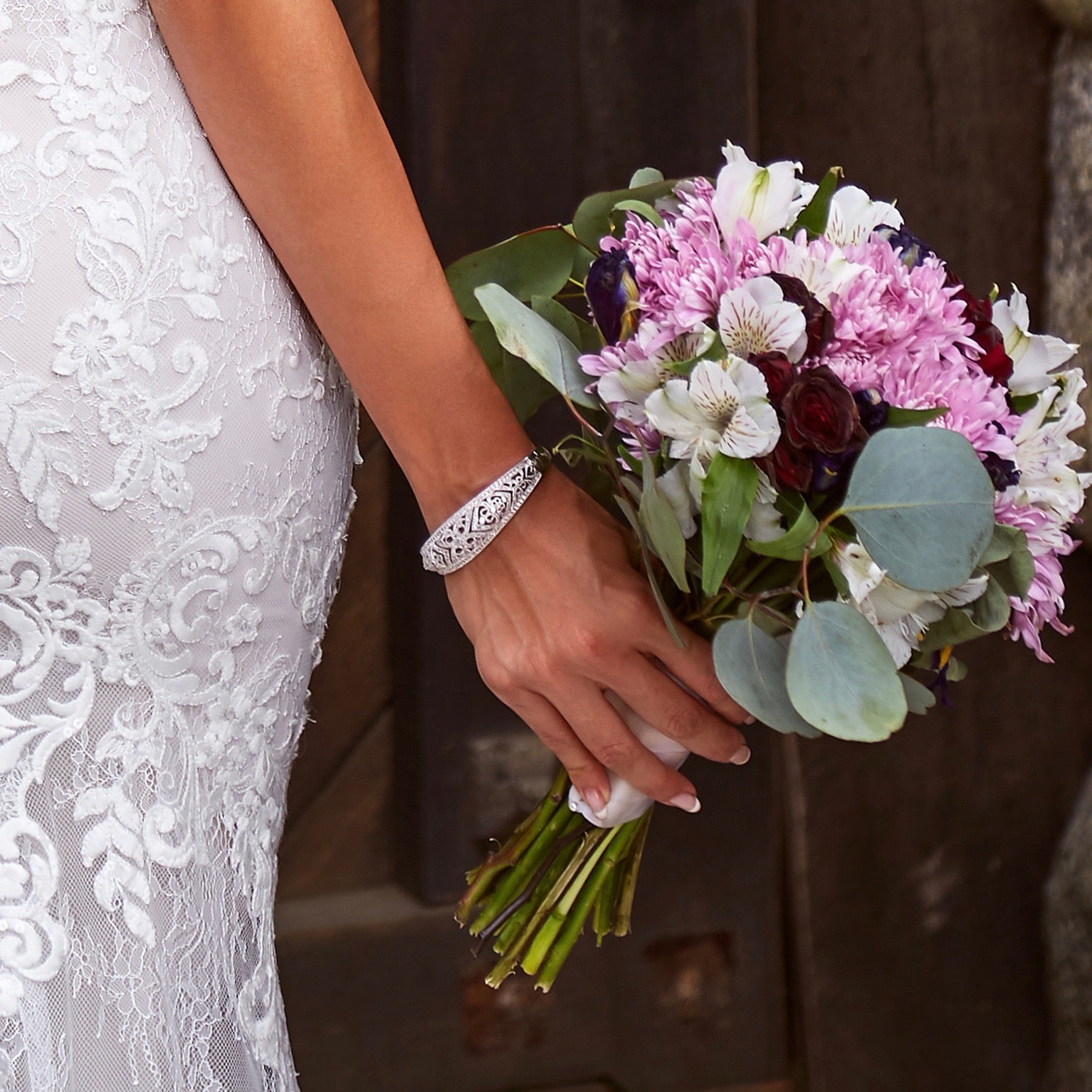 Madelena Art-Deco Inspired Bangle Bracelet Model Wearing Kitty Chen Couture and Holding a bouquet of Flowers