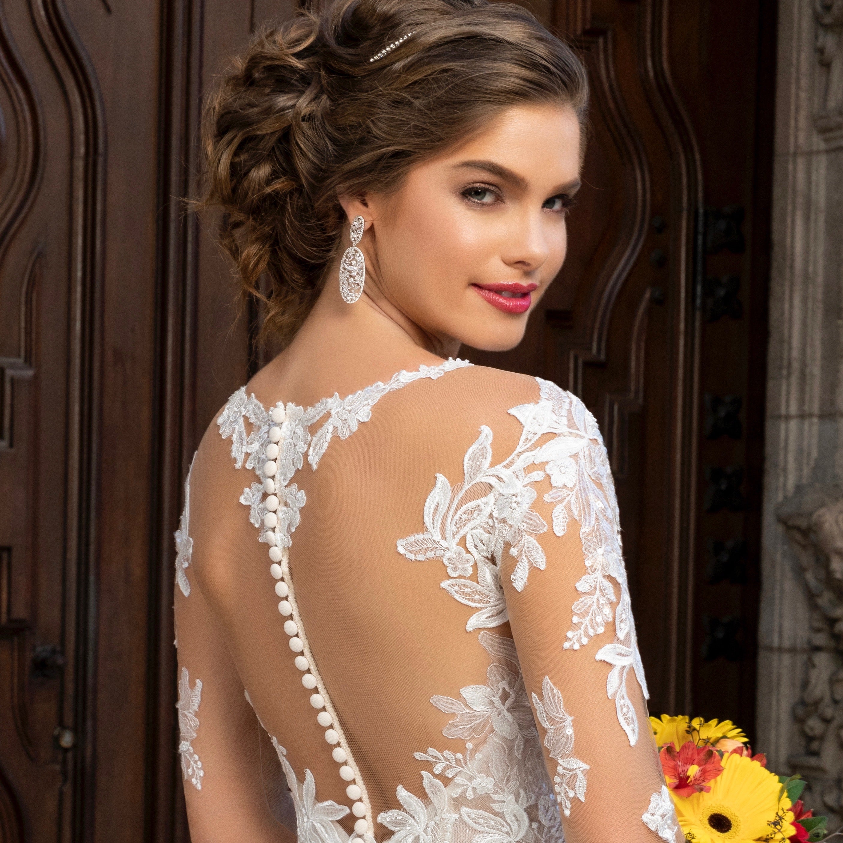 Estelle Floral Statement Earrings on a Bride in front of a Big Doors.