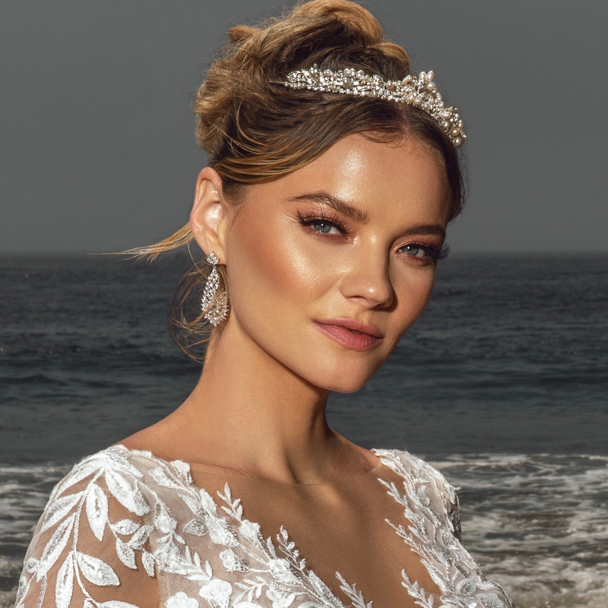 Grayson Statement Earrings on a model at the Ocean.