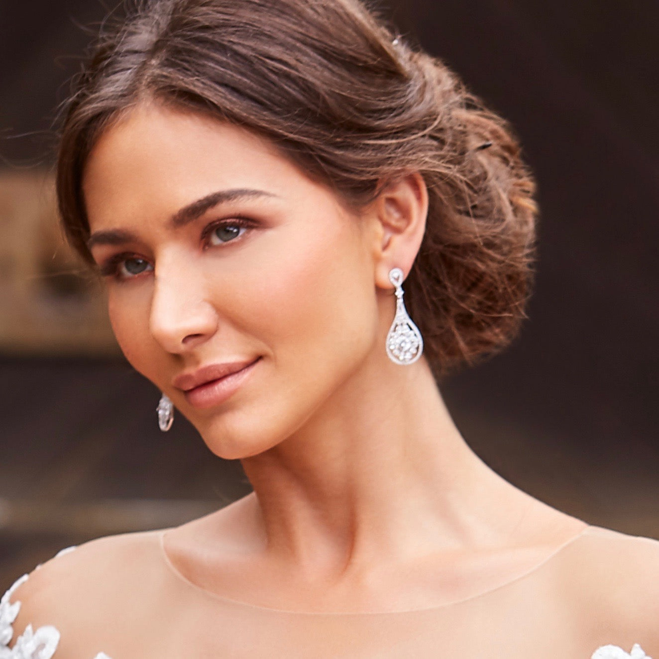 Guenevere Crystal Statement Earrings close up on a model wearing them from Anna Bellagio. 