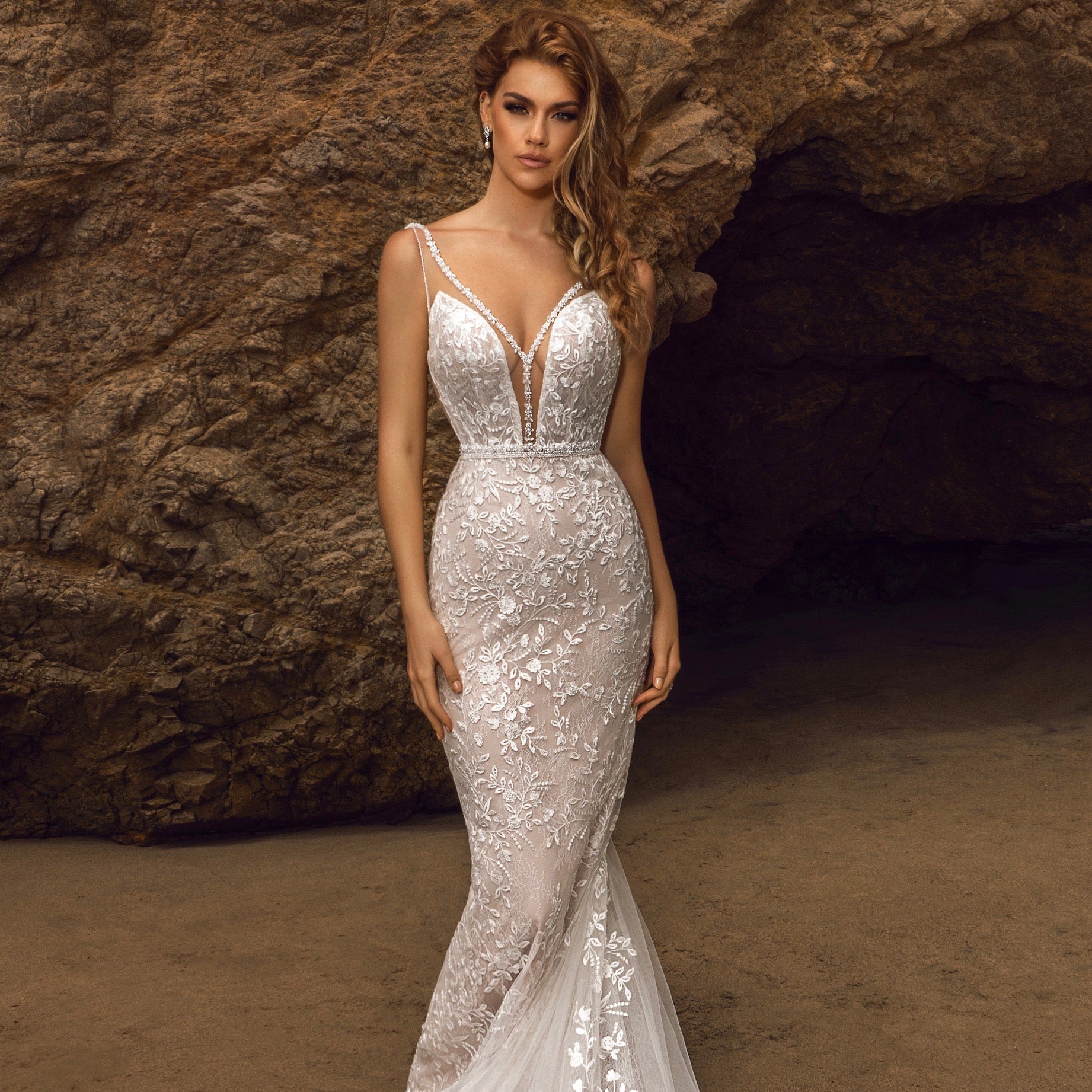 Kiya Freshwater Pearl and Crystal Earrings on a Bride in front of a huge rock at the ocean. 